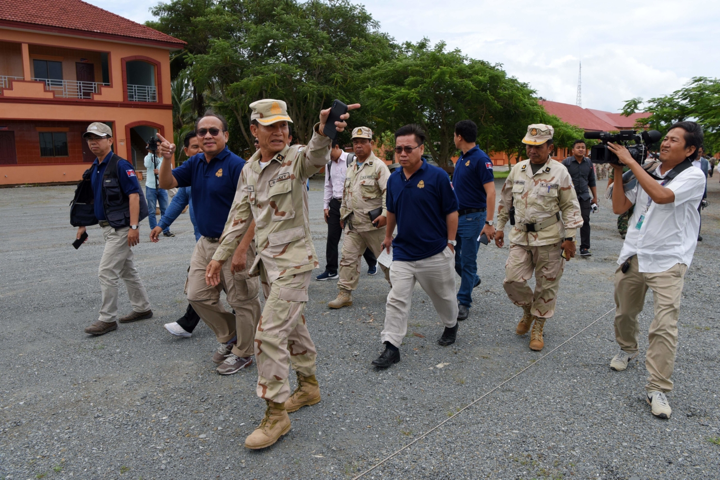 Cambodian Naval General Ouk Seyha (centre L) guides journalists on a government organised media tour to the Ream naval base in Preah Sihanouk province on July 26, 2019. - Cambodia on July 25 rubbished reports of a deal allowing China to use a naval base as 