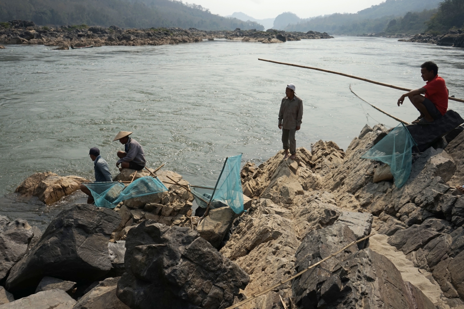 This photo taken on February 8, 2020 shows fishermen laying their nets on the Mekong River near Luang Prabang close to the site of an approved Laos dam site. - Environmentalists on May 12, 2020 have criticised Laos for pressing ahead with plans for another "destructive dam" on the Mekong River, a waterway already strangled by hydropower schemes. (Photo by Aidan JONES / AFP) (Photo by AIDAN JONES/AFP via Getty Images)